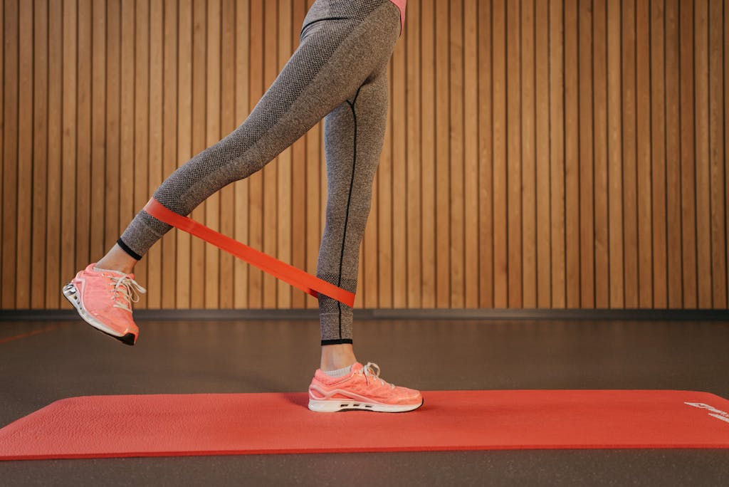 Person in Gray Leggings and Pink Sneakers Exercising